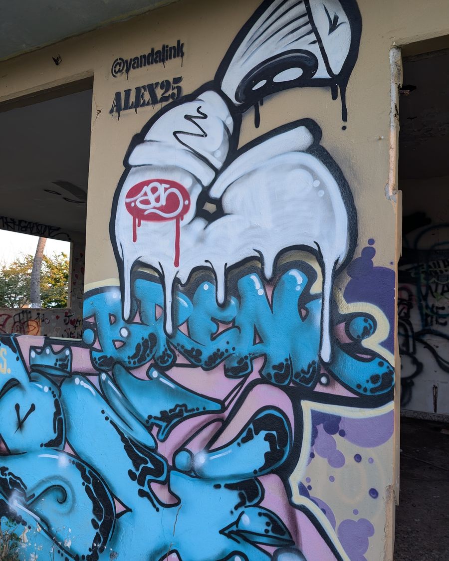 Spray can dripping with paint beside bold graffiti lettering on a concrete column