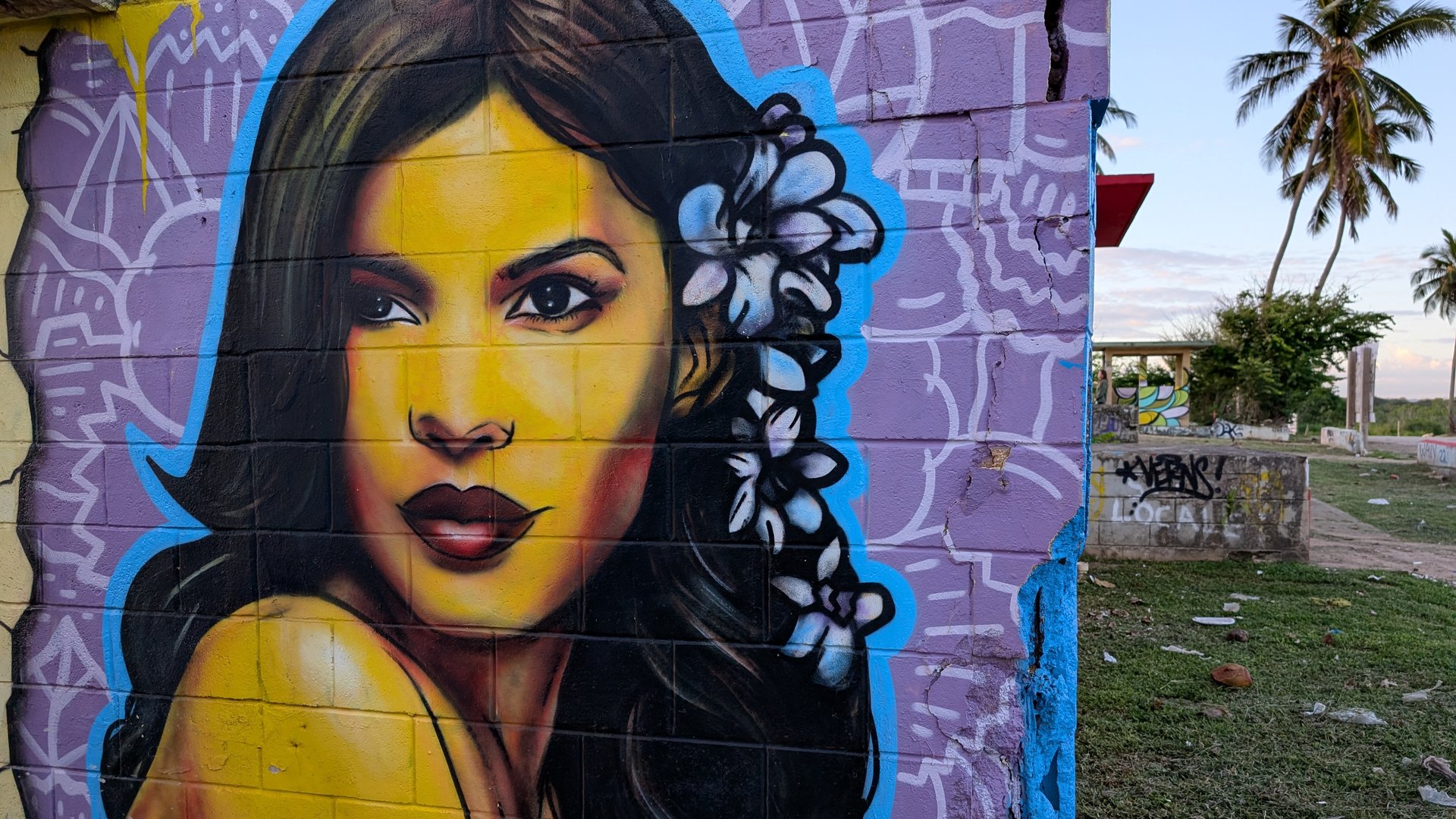 Vibrant large-scale mural depicting a woman's face in bold colors