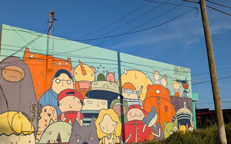 Large-scale cartoon mural covering the facade of an urban building